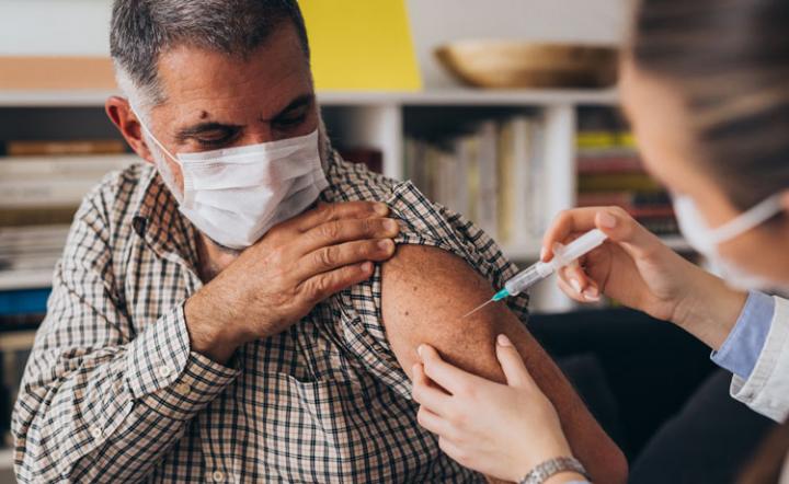 man getting a vaccine in his arm